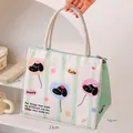 Portable insulated lunch bag with cute dog pattern and cotton rope handles in mint green - Whimsical Dog