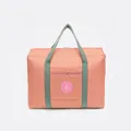 Large capacity waterproof travel duffel bag with peach pink fabric and green straps - Round Label Gen 2 / Pink