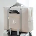 Beige waterproof large capacity travel duffel bag attached to silver suitcase handle - Round Logo Bag / Khaki
