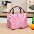 Portable pink and white striped insulated lunch bag with durable brown handles - Pink