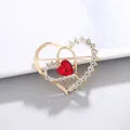 Elegant gold heart brooch featuring sparkling crystals and a central red heart gemstone. - Double Heart Style (XD11034)