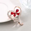 Elegant rose gold heart-shaped brooch featuring red crystal butterfly and sparkling rhinestones - Red Butterfly Heart Style (XD11048-1)