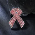 Close-up detail of a silver-tone brooch with pink rhinestones in ribbon shape - Pink Ribbon
