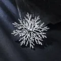 Detailed view of an elegant silver snowflake brooch with a grey pearl center piece - Silver & Grey Pearl Snowflake