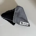 Detailed view of gingham and lace triangular hair claw clip with white wavy edge - Black and White Grid Triangle Hair Claw