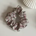Detail view of a sweet pink and white plaid fabric hair scrunchie with ruffled edges. - White Pink Striped Scrunchie / Pink and White