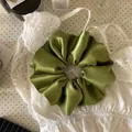 Premium mustard green satin scrunchie hair tie showing smooth texture and elegant folds - Large Scrunchie / Mustard Green