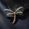 Macro view of exquisite alloy dragonfly brooch featuring sparkling diamonds and amber crystals - Dragonfly