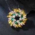 Close-up of a luxurious flower wreath brooch with sparkling yellow and green crystals - Wreath Style (XD825349)