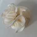Detailed view showing the shimmering texture of an oversized pleated cream satin scrunchie - Off-White Texture Style / Off White