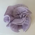 Close-up detail of a large light purple pearlescent pleated satin hair scrunchie - Purple Textured Style / Purple