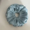 Top-down view showing the shimmering texture of a light blue pleated large scrunchie - Ruffled Scrunchie / Green