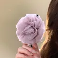 Elegant light purple chiffon flower banana hair clip held by hand for detail. - Purple Tulle Flower