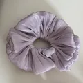 Close-up of shimmering pleated lavender scrunchie showing fine fabric texture - Ruffled Scrunchie / Purple
