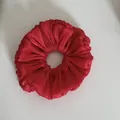 Close-up detail showing the shimmering pleated texture of this large red fabric scrunchie - Ruffled Scrunchie / Red