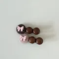Detailed view of two cute hair clips with pink bows and brown glossy beads - Coffee Striped Oval Red Ball Hair Clip / One Pair