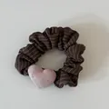 High-quality detailed view of a dark brown pinstriped scrunchie with a pink heart - Pink Heart Coffee Striped Scrunchie