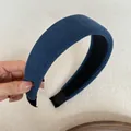 Detailed macro shot of a wide blue ribbed sponge headband with soft texture. - Wide Padded / Dark Blue Striped Headband