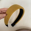 Detailed close-up view of a yellow corduroy padded headband showing soft ribbed texture - Wide Padded / Ginger Yellow Ribbed Headband