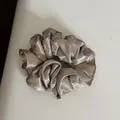 Detail view of a champagne satin scrunchie featuring elegant white bow patterns - Hair Tie / Coffee