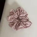 Close-up of rose pink satin scrunchie featuring elegant white bow embroidery details - Hair Tie / Pink