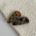 Close-up of vintage mustard plaid hair clips with wooden buttons and blue accents - Yellow Striped Teardrop Hair Clips (Pair)