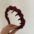 Close-up detail of burgundy striped fabric headband featuring black shark teeth grips - Red Striped Headband with Teeth