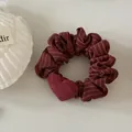 Detailed view of elegant wine red striped hair scrunchie featuring a soft plush heart charm - Red Striped Heart Hair Tie