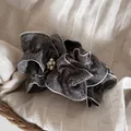 Detailed view of elegant black and white ruffled fabric bow hair clip with pearls - Gray Ruffle Pearl Style