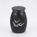 Detailed view of black memorial urn with white peace dove pattern for pet ashes - Black (25x16mm)