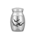 Detailed view of silver stainless steel cremation urn featuring elegant flying bird design - Silver (25x16mm)