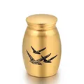 Detailed close-up view of a small gold memorial cremation urn with engraved black birds - Gold (25x16mm)