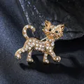 Macro view of a gold-plated cat brooch sparkling with white and black rhinestones - Gold Cat