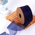 Detail view of dark blue organza ribbon on a craft cardboard spool for gift wrapping. - 4CM Wide x 9.14 Meters Long / Seasonal Blue
