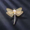 Detail view of a dragonfly brooch with a freshwater pearl and mesh wings - Gold