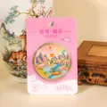 Detailed macro view of a Guilin Li River souvenir metal coin with pink card packaging - Guilin Commemorative Coin / Lijiang River