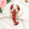 Macro view of a vintage red lobster brooch featuring rhinestones and enamel details - KC Gold Red Lobster