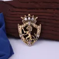 Close-up of a vintage crown lion shield brooch in antique gold finish with clear rhinestones - Ancient Copper White Rhinestone
