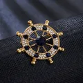 Elegant ship wheel brooch in gold alloy with sparkling blue and clear rhinestones - Ship Rudder (XD825300)