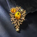 Elegant vintage floral brooch pin featuring yellow crystals on a gold alloy base. - Yellow Glass Flower