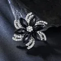 Elegant black crystal flower brooch with clear rhinestones set in a silver-toned alloy - Black Floral