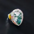 Detailed macro shot of vintage teardrop ring featuring a moss stone and rhinestone halo - Retro Irregular Stone (Open)