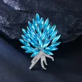 Close-up of elegant light blue crystal bouquet brooch with silver rhinestone stem detail - Silver-White with Lake Blue