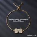 Detailed shot showing the length and weight of a gold adjustable bracelet with zircon - Bow Center Blue Gem Style (SL108-2) / Gold