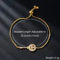 Detail showing adjustable gold zircon bracelet with key and smiley face charm weighing 6.1g - Key and Smile (SL344-2)
