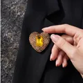 Premium heart shaped brooch with amber crystals pinned on an elegant black blazer lapel - Antique Gold Light Coffee Heart
