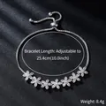 Macro view of adjustable silver flower zircon bracelet with sparkling crystal accents - Seven Small Flowers Style (SL305) / Slider Adjustment / White Gold