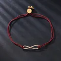 Elegant red cord infinity charm bracelet featuring sparkling cubic zirconia stones. - Infinity Symbol Style (SL217-12) / Dark Red