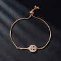 Elegant rose gold adjustable bracelet featuring a smiley face key charm paved with zircons - Key and Smile (SL344-3)