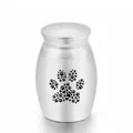 Small silver stainless steel pet cremation urn featuring a detailed paw print design - Silver